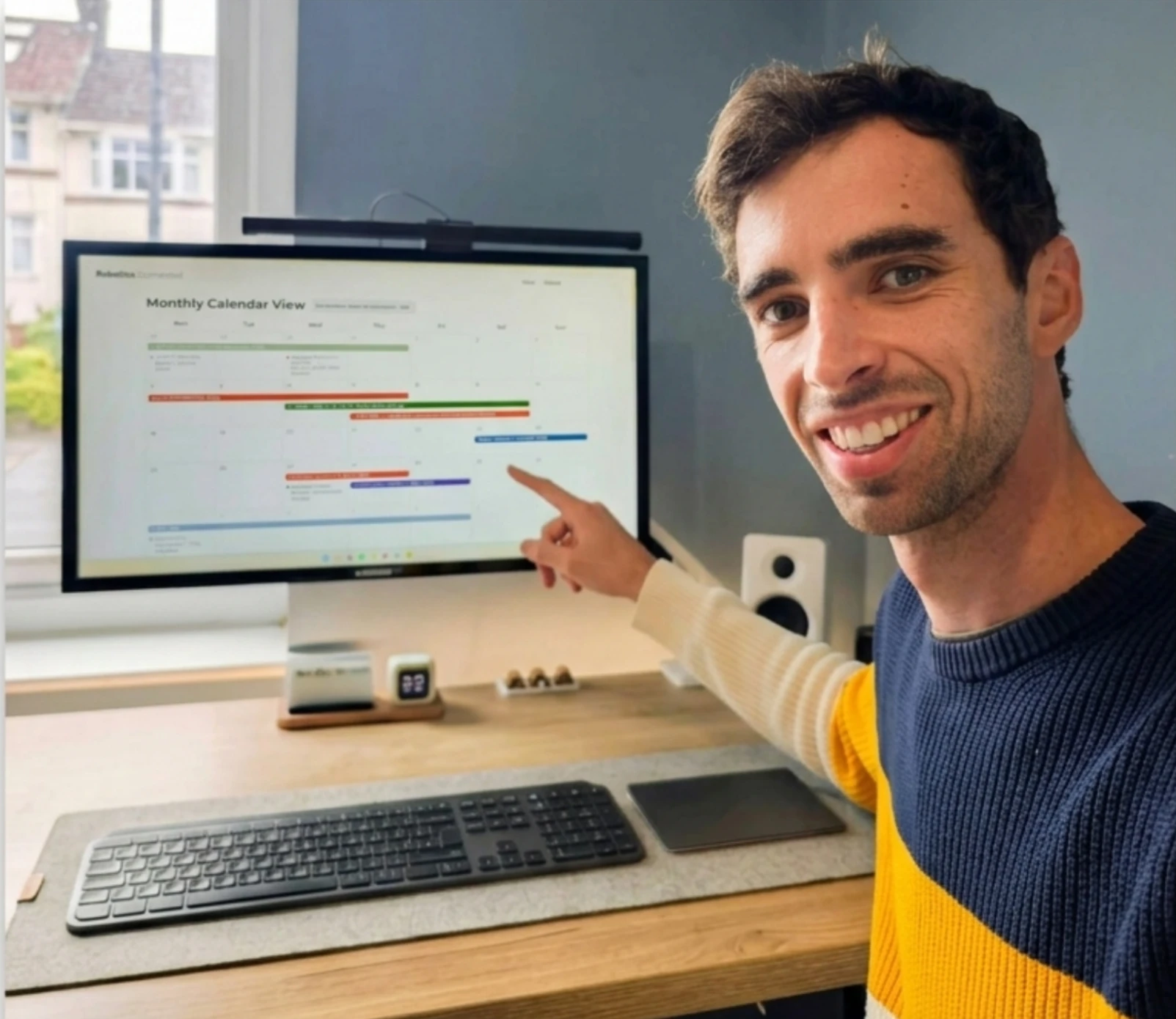 A hand pointing at the first Robotics Connected events calendar on a monitor